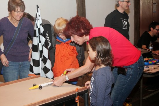 A Raytheon engineer teaches children about propellers using a rocket car.